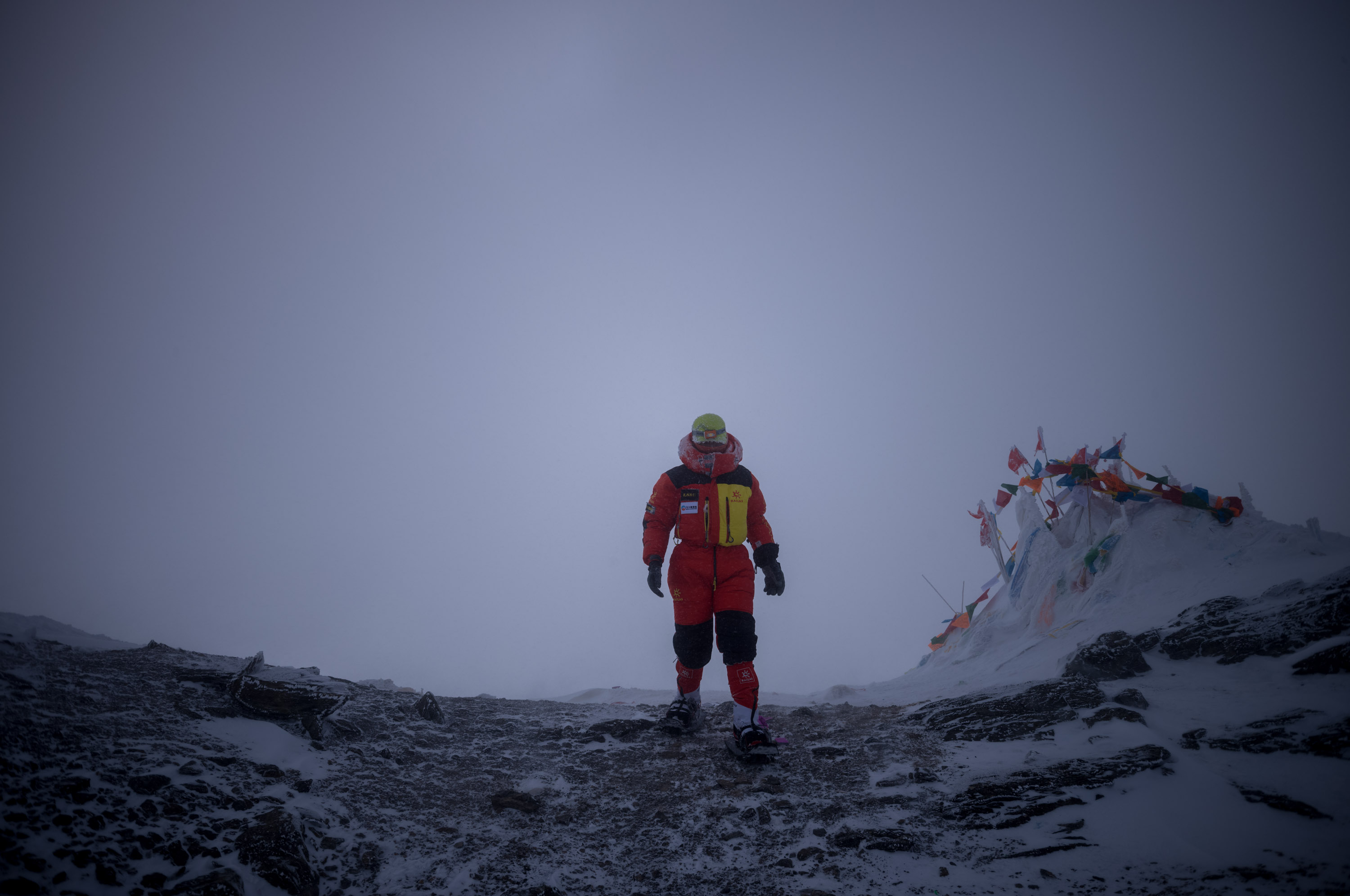 Guide Zhaxi stands at the summit. 向导扎西站在海拔7546米的顶峰.